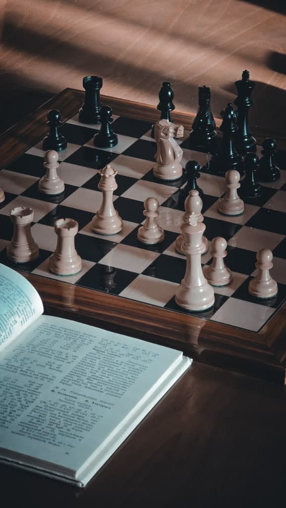 Chessboard with chess tactics and strategy book