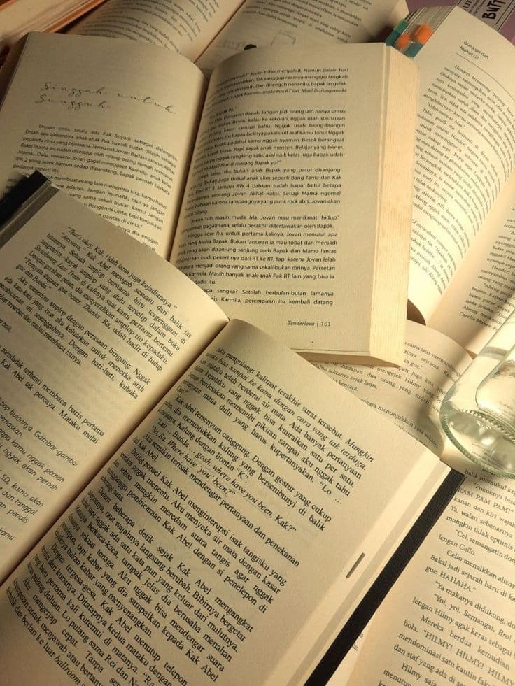 Stack of open books reflecting literature and self-growth